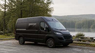 Kompakter schwarzer Hymer Sydney Campingbus an einem See
