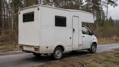 Kompaktes einfaches Wohnmobil auf kleiner Transporterbasis an einer Landstraße